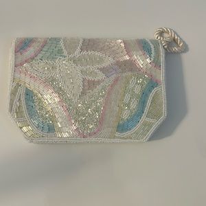 White, small-beaded, clutch with snap.
